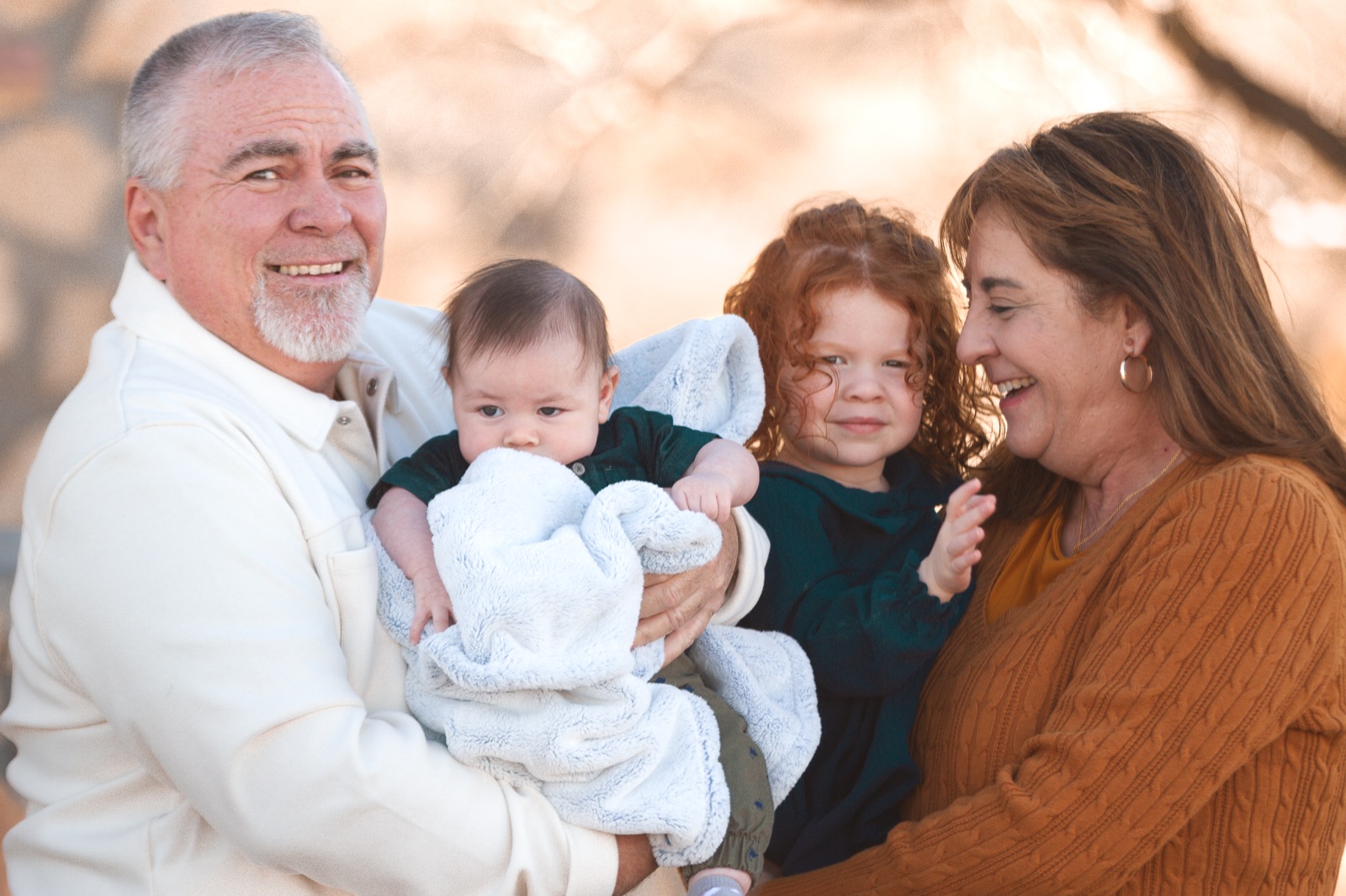 Three generations together in warm sunlight