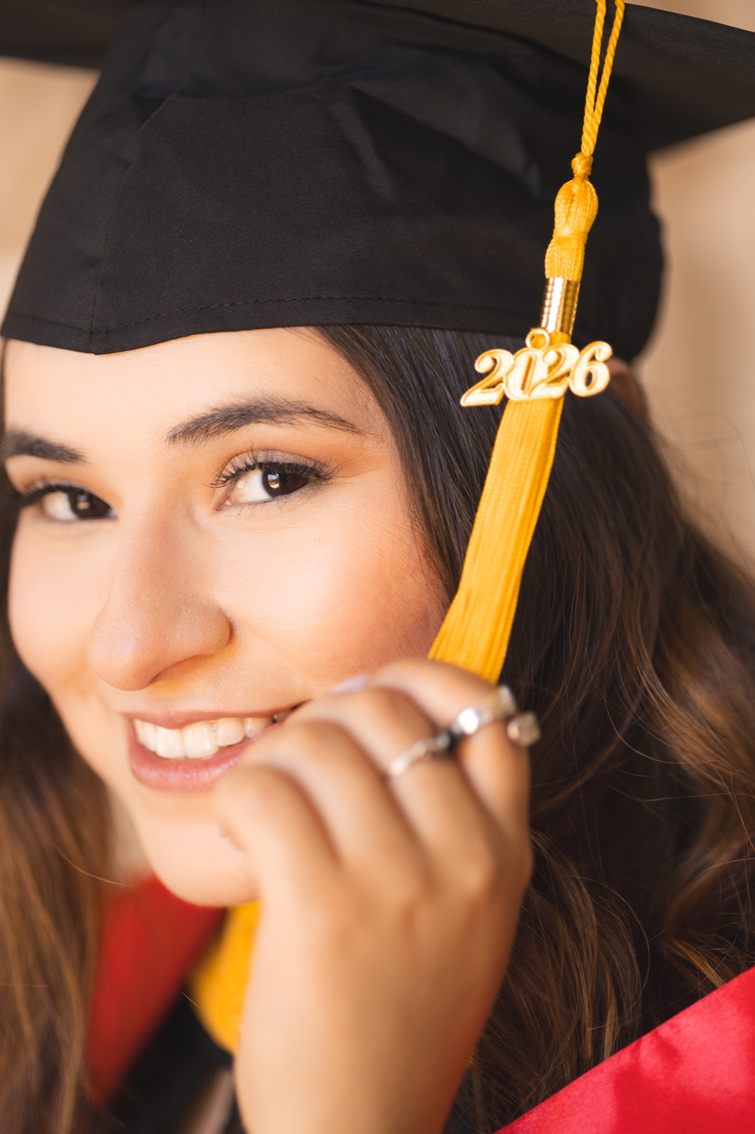 A graduate smiling in her cap